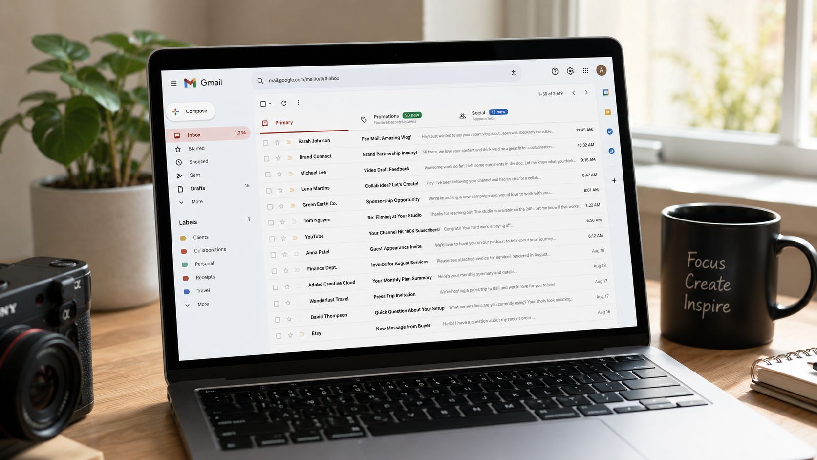 A laptop screen displaying the Gmail inbox interface with a sidebar showing various custom email labels.